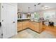 Open kitchen area with wooden cabinets, granite countertops, and seamless flow to living spaces at 14350 11Th St, Dade City, FL 33523