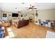 Spacious living room features wood floors, ceiling fans, and comfortable seating at 14350 11Th St, Dade City, FL 33523