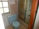 Small bathroom featuring tiled shower, toilet and a window at 14614 Lake Magdalene Cir, Tampa, FL 33613