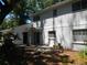 Backyard featuring a white exterior, patio, and sliding glass doors at 14614 Lake Magdalene Cir, Tampa, FL 33613