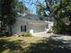 A two-story white house with an attached garage and a driveway at 14614 Lake Magdalene Cir, Tampa, FL 33613