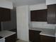 A kitchen features basic cabinets and counters, ready for updates to suit a modern lifestyle at 14614 Lake Magdalene Cir, Tampa, FL 33613