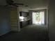 An open-concept living room and kitchen area featuring neutral tones and sliding glass doors at 14614 Lake Magdalene Cir, Tampa, FL 33613