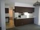 The living room flows into the kitchen, featuring a breakfast bar, appliances, and natural light at 14614 Lake Magdalene Cir, Tampa, FL 33613