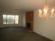Bright living room featuring a charming chandelier, fireplace and window views, creating a cozy space at 14614 Lake Magdalene Cir, Tampa, FL 33613