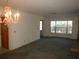 Spacious living room with a chandelier, natural lighting, and fireplace, providing an inviting and comfortable space at 14614 Lake Magdalene Cir, Tampa, FL 33613