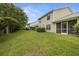 Exterior view of home with a spacious backyard at 1640 Lullwater Ln, Lutz, FL 33549