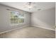 Bright bedroom with hardwood floors and a large window offering abundant natural light and view at 1640 Lullwater Ln, Lutz, FL 33549