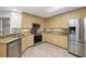 Modern kitchen featuring stainless steel appliances, wooden cabinets, granite counters, and stylish backsplash at 1640 Lullwater Ln, Lutz, FL 33549