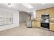 Well-lit kitchen with stainless steel appliances, wooden cabinets, and granite countertops with an open floor plan at 1640 Lullwater Ln, Lutz, FL 33549