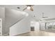 Spacious living room with high ceilings, wood flooring, staircase, and ample natural light from nearby windows at 1640 Lullwater Ln, Lutz, FL 33549