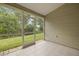 Screened patio featuring tile floors and a backyard view at 1640 Lullwater Ln, Lutz, FL 33549