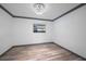 Contemporary bedroom featuring wood-look floors, gray trim, and a decorative ceiling light fixture at 1820 Mississippi Ave Ne, St Petersburg, FL 33703