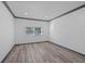 Bright, minimalist bedroom with wood-look floors and neutral walls, offering a serene and versatile space at 1820 Mississippi Ave Ne, St Petersburg, FL 33703