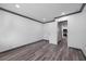 Bright bedroom with wood-look floors, neutral walls, and a doorway to another room at 1820 Mississippi Ave Ne, St Petersburg, FL 33703