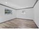 Bedroom showcasing wood-look flooring, neutral paint, and natural lighting at 1820 Mississippi Ave Ne, St Petersburg, FL 33703