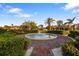 Circular community water fountain encircled by lush landscaping and verdant trees at 1820 Mississippi Ave Ne, St Petersburg, FL 33703