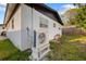 The exterior of the home features an air conditioner and a well maintained backyard at 1820 Mississippi Ave Ne, St Petersburg, FL 33703
