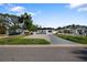 Charming single-story house featuring a well-manicured lawn, long driveways, and a welcoming facade at 1820 Mississippi Ave Ne, St Petersburg, FL 33703