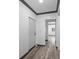 Hallway featuring wood-look floors, white walls, and gray trim, creating a modern and clean aesthetic at 1820 Mississippi Ave Ne, St Petersburg, FL 33703