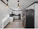 Modern kitchen with stainless steel appliances, stylish pendant lights, and black granite countertops at 1820 Mississippi Ave Ne, St Petersburg, FL 33703