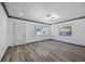 Inviting living room with gray wood floors, natural light, and a decorative front door at 1820 Mississippi Ave Ne, St Petersburg, FL 33703