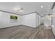 Bright living room with hardwood floors, modern ceiling light, and a view to the yard at 1820 Mississippi Ave Ne, St Petersburg, FL 33703