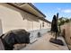 A covered grill and umbrella with outdoor seating on the home's concrete patio offer relaxation at 1820 Mississippi Ave Ne, St Petersburg, FL 33703