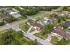 An aerial shot of a neighborhood showcasing lush landscaping, winding roads, and beautiful homes at 1915 Belleair Rd, Clearwater, FL 33764