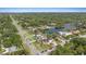 An aerial view showcasing the homes situated near a picturesque lake and lush green landscape at 1915 Belleair Rd, Clearwater, FL 33764