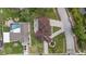An aerial view of a home with a unique roof, a patio with furniture, and well-maintained landscaping at 1915 Belleair Rd, Clearwater, FL 33764