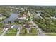 An aerial view of neighborhood homes bordering scenic lake waters and lush green landscape at 1915 Belleair Rd, Clearwater, FL 33764