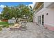 Beautifully landscaped backyard featuring a stone patio, fire pit, and lush greenery at 1915 Belleair Rd, Clearwater, FL 33764