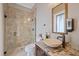Elegant bathroom featuring a glass shower, granite countertop, and a modern vessel sink at 1915 Belleair Rd, Clearwater, FL 33764