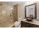 Bathroom with granite countertop, unique bowl sink, and glass enclosed shower at 1915 Belleair Rd, Clearwater, FL 33764