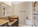 Bathroom with granite countertop, unique bowl sink, and glass enclosed shower at 1915 Belleair Rd, Clearwater, FL 33764