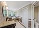 Elegant bathroom with dual sinks, a soaking tub, and decorative tile at 1915 Belleair Rd, Clearwater, FL 33764