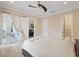 Spacious bedroom with access to the balcony through the French doors and a ceiling fan at 1915 Belleair Rd, Clearwater, FL 33764