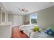 Bedroom with hardwood floors, ceiling fan, window, and closet at 1915 Belleair Rd, Clearwater, FL 33764