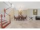 Elegant dining room with a chandelier, dining table, staircase and marble floors at 1915 Belleair Rd, Clearwater, FL 33764