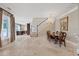 The dining room is open to the staircase and kitchen, featuring marble floors at 1915 Belleair Rd, Clearwater, FL 33764
