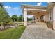 Inviting front entrance with stone pavers, arched entryway, and meticulously landscaped garden at 1915 Belleair Rd, Clearwater, FL 33764