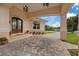 Inviting front entrance with stone pavers, arched entryway, and potted plants at 1915 Belleair Rd, Clearwater, FL 33764