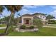 Charming home with lush landscaping and a welcoming entryway with a curved brick walkway at 1915 Belleair Rd, Clearwater, FL 33764