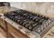 Viking gas cooktop with granite countertops and wood cabinetry at 1915 Belleair Rd, Clearwater, FL 33764