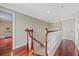 Hallway with wood floors and access to multiple rooms at 1915 Belleair Rd, Clearwater, FL 33764