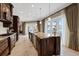 Spacious kitchen with large center island, stone countertops, stainless appliances, and light-filled windows at 1915 Belleair Rd, Clearwater, FL 33764