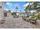 Large backyard patio with outdoor seating, fire pit and pizza oven at 1915 Belleair Rd, Clearwater, FL 33764