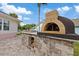 Outdoor kitchen features a custom pizza oven and ample counter space for entertaining at 1915 Belleair Rd, Clearwater, FL 33764