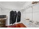 Walk-in closet with custom shelving, granite countertops, and wood floors at 1915 Belleair Rd, Clearwater, FL 33764